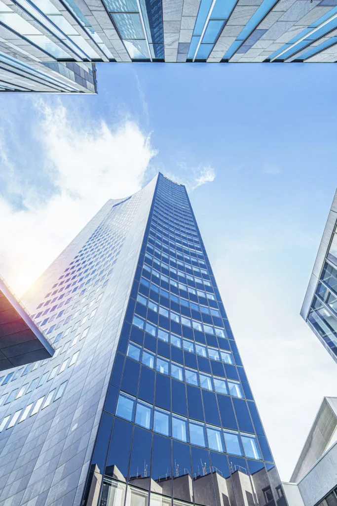 The Panorama Tower between glass facades against the light