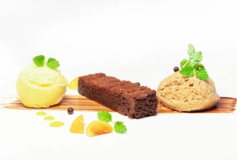 Dessert with brownie, ice cream and nougat quenelle