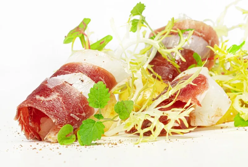 Starter with air-dried ham and frisée salad