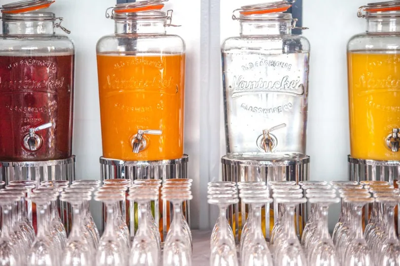 Dispensers with fresh juices above glasses