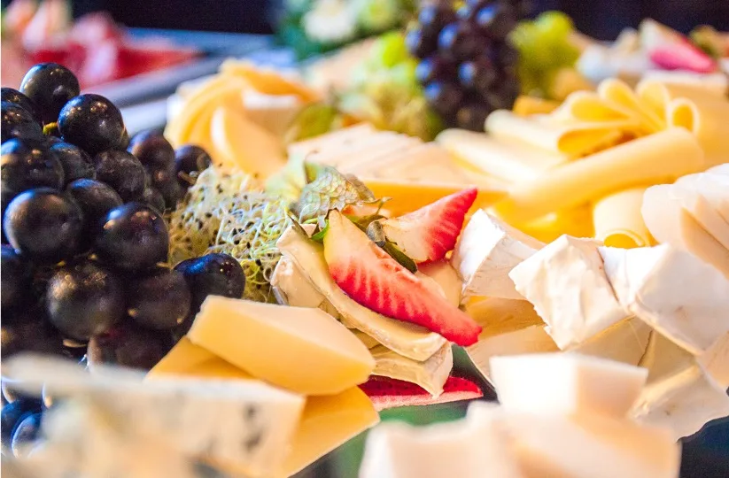 Cheese platter with grapes and strawberries
