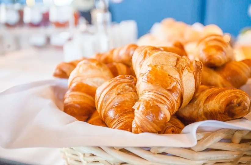 Croissants in a bread basket at the breakfast buffet