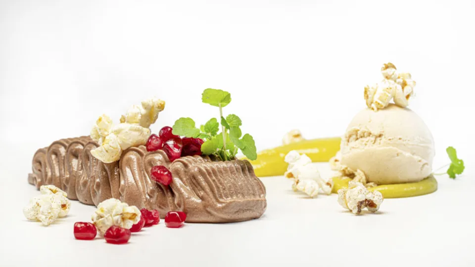 Schokoladendessert mit Granatapfel, Popcorn und Eis